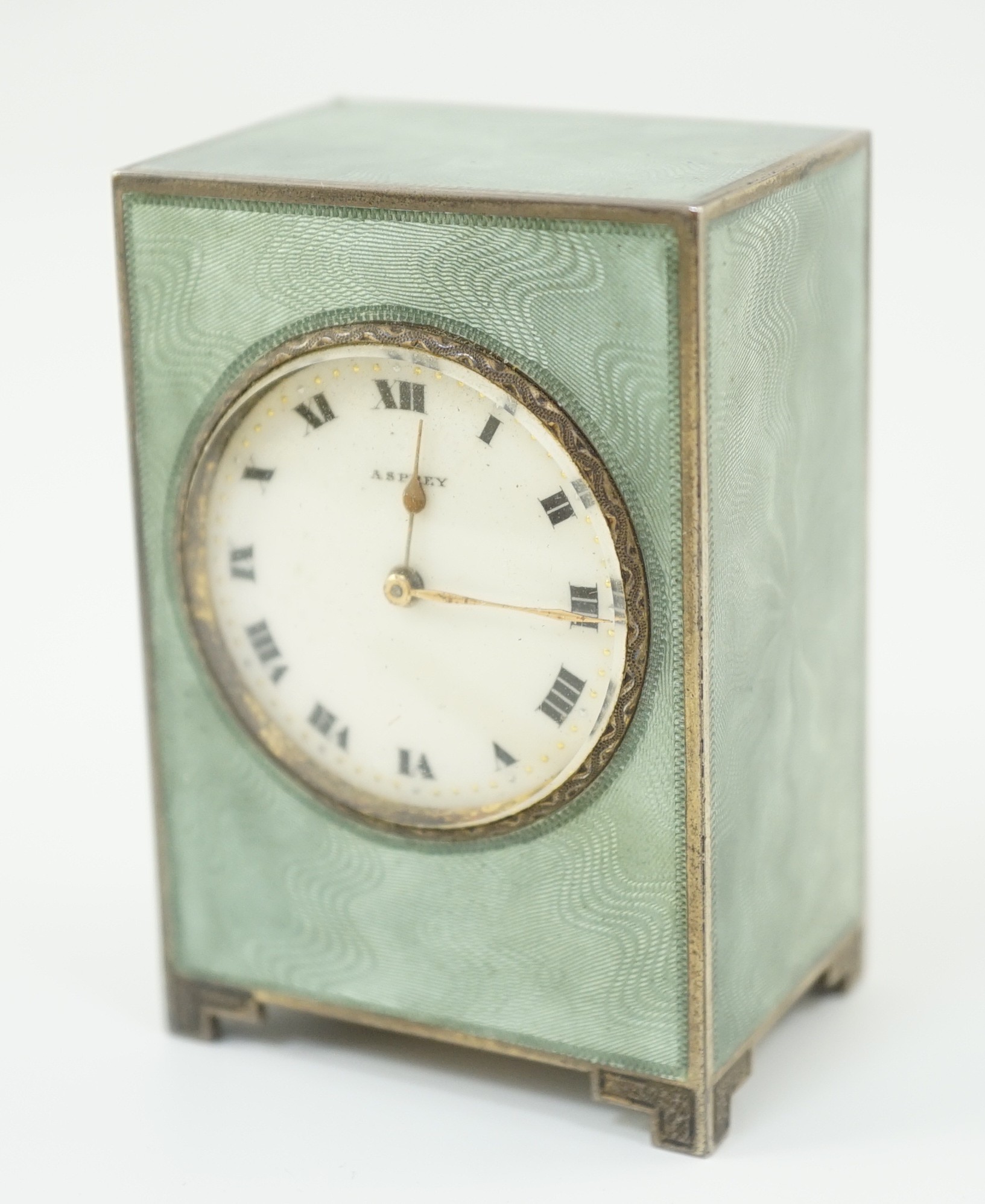 A George V silver and green guilloche enamelled travelling timepiece, retailed by Asprey, in original case